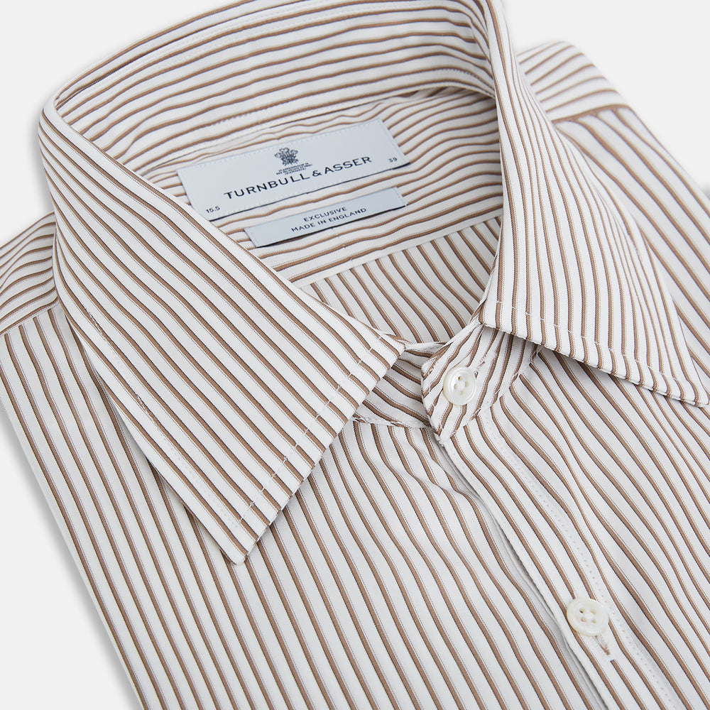 The Turnbull & Asser Coffee Multi Stripe Westminster Shirt features long sleeves, a button-up front, subtle beige and white stripes, a pointed Turnbull collar, and buttoned cuffs—expertly crafted in Britain and shown flat on a white background.