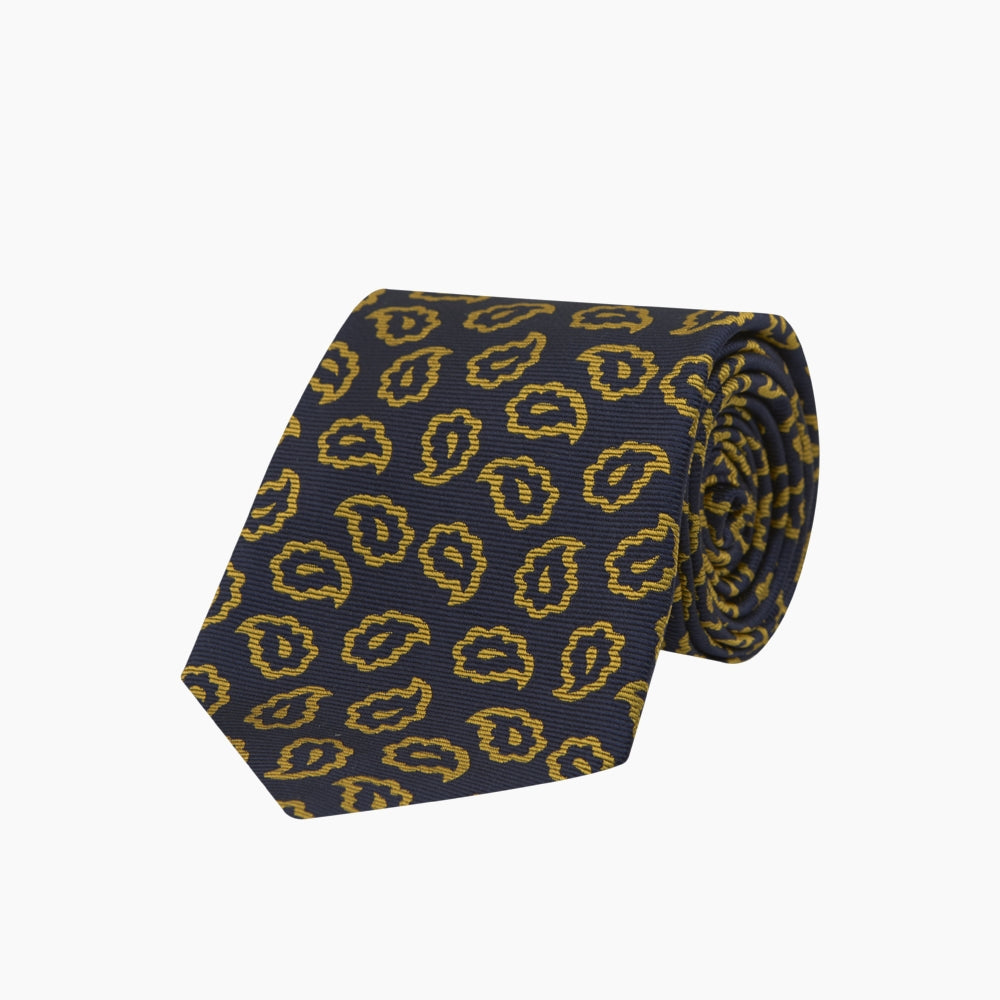 The Navy and Gold Petal Paisley Silk Tie by Turnbull & Asser features a repeating yellow abstract pattern, neatly rolled on a white background.