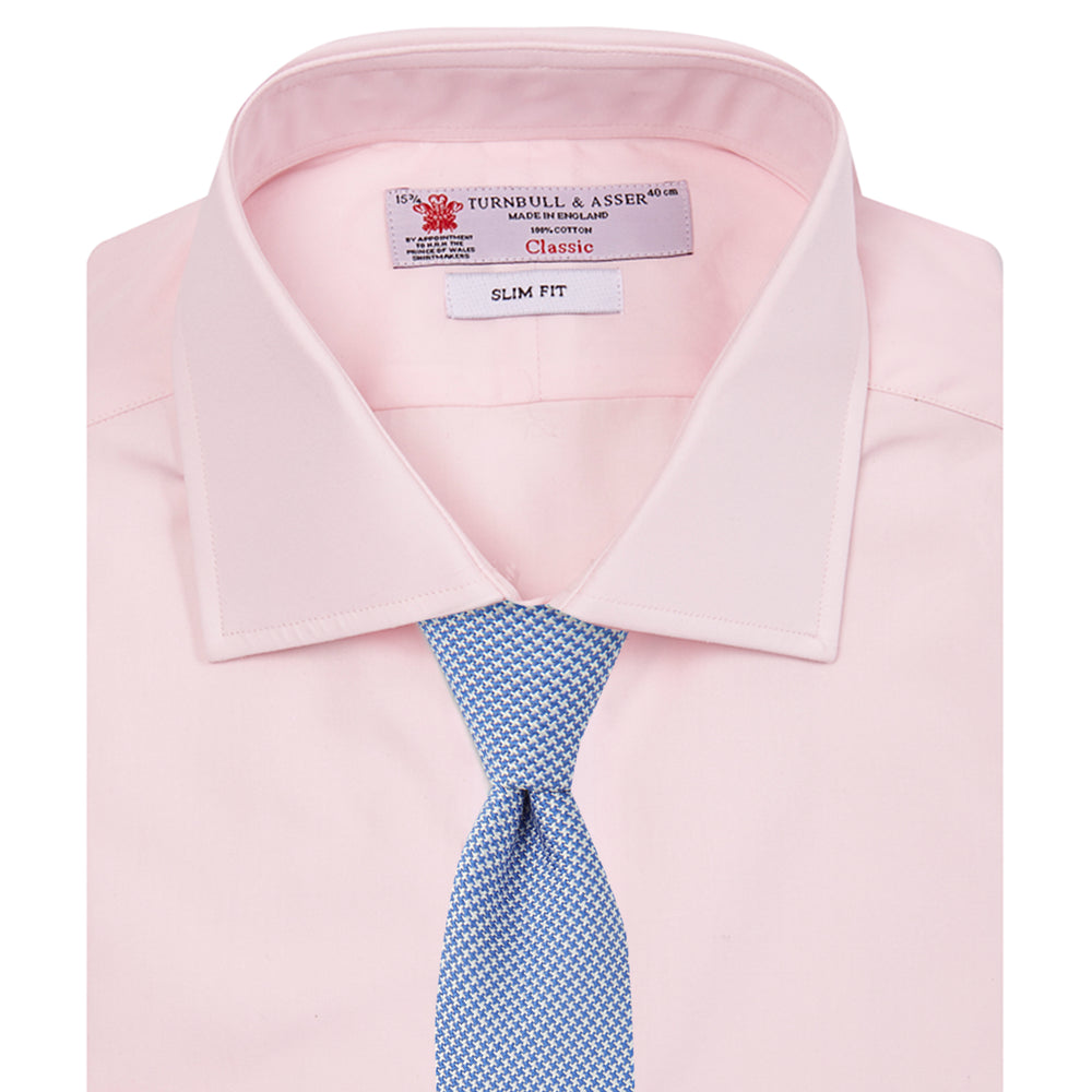 The Turnbull & Asser Pink Poplin Slim Fit Regent Collar Shirt features white buttons and a slim fit label, neatly folded and displayed on a plain white background.
