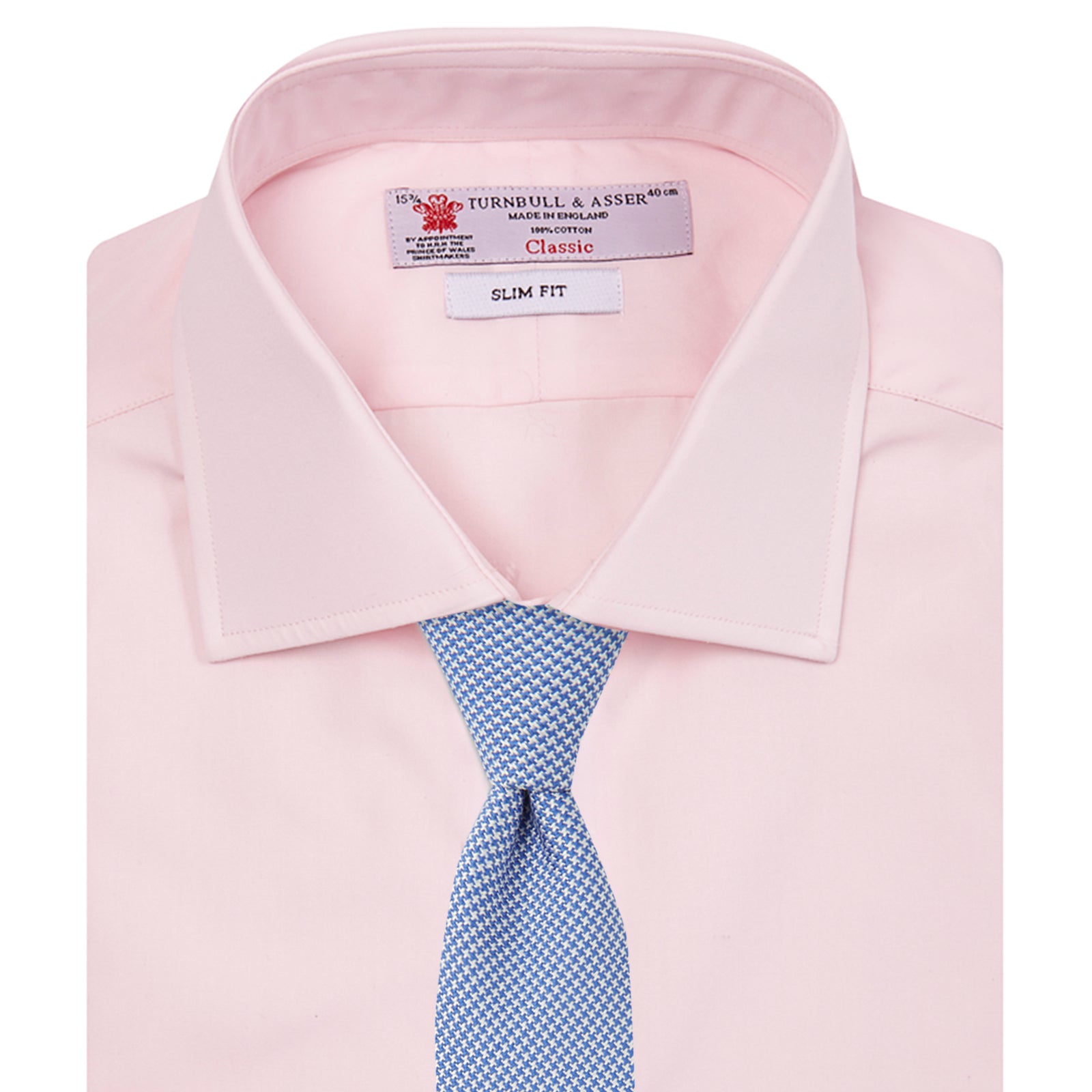 View 3 of product The Turnbull & Asser Pink Poplin Slim Fit Regent Collar Shirt features white buttons and a slim fit label, neatly folded and displayed on a plain white background.