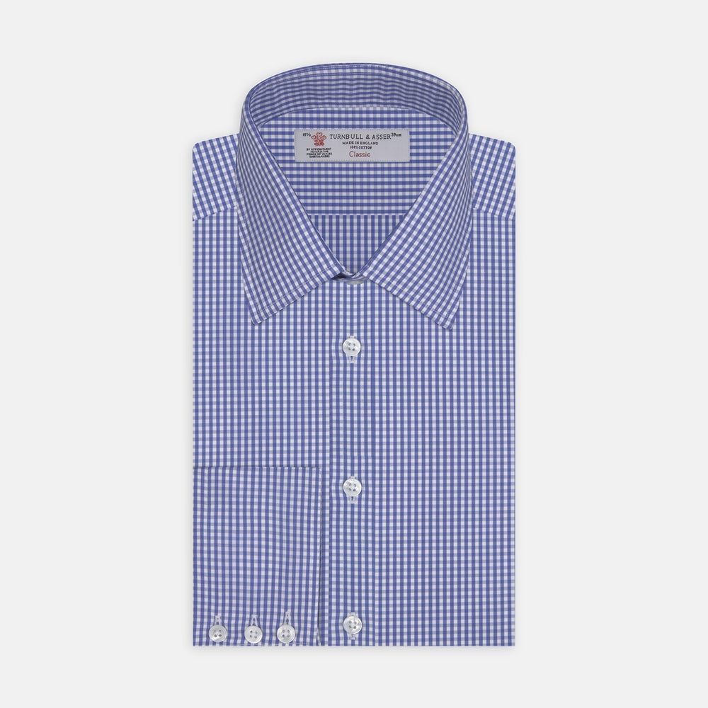 A circular swatch of Turnbull & Asser's Mid Blue Gingham Check Cotton Fabric, featuring a blue and white check pattern and a gray border, is shown against a plain white background.