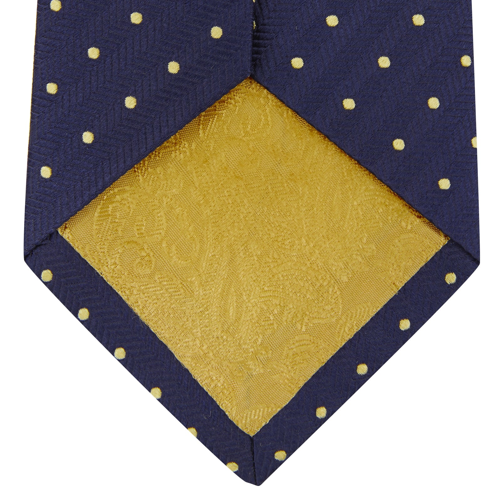 View 3 of product The Turnbull & Asser Navy Spot Woven Herringbone Silk Tie features a navy blue base with evenly spaced yellow polka dots, making it an essential accessory for smart attire. Displayed rolled on a white background.