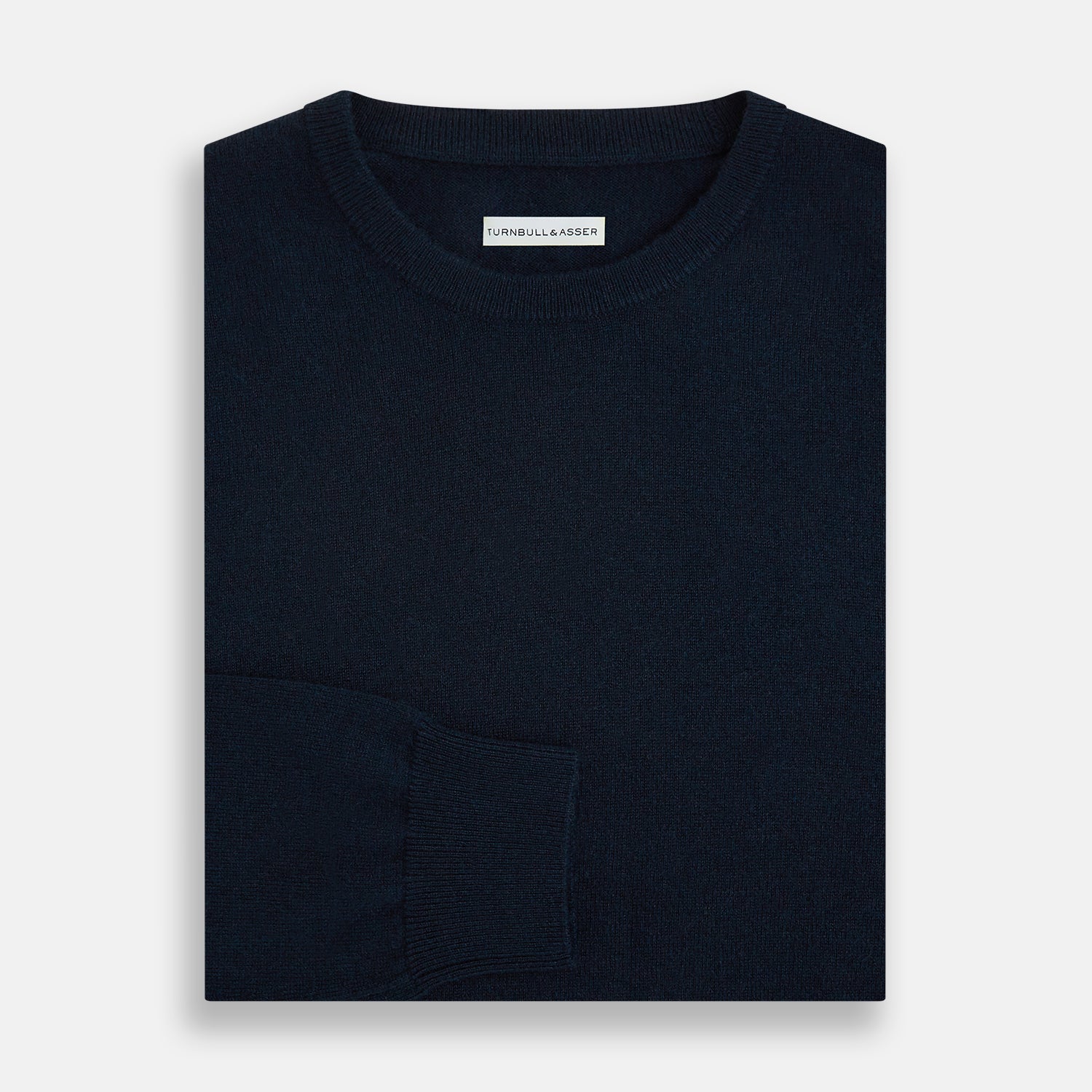 View 4 of product The Turnbull & Asser Navy Cashmere Round Neck Jumper for men is shown against a white background, featuring long sleeves, a relaxed fit, and ribbed cuffs, hem, and collar for an effortlessly elegant look.