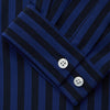 View 2 of product The Turnbull & Asser Navy and Blue Multi Stripe Silk Holiday Fit Winnington Shirt features white buttons, a notched collar, and a chest pocket, shown laid flat on a white background.