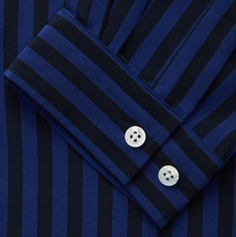 The Turnbull & Asser Navy and Blue Multi Stripe Silk Holiday Fit Winnington Shirt features white buttons, a notched collar, and a chest pocket, shown laid flat on a white background.