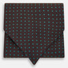 View 1 of product The Turnbull & Asser Blue and Dark Brown Micro Dot Silk Cravat features evenly spaced blue micro dots on dark brown silk, displayed neatly folded on a white background.