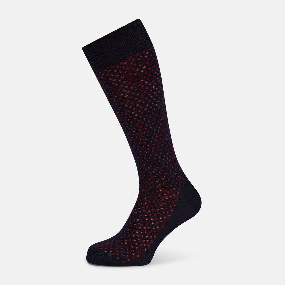 A single Navy/Red Motif Mid-Length Sock by Turnbull & Asser, displayed upright on a white background. The sock features a calf-length style, ribbed cuff, hand-linked toe for comfort, and a subtle red pattern.