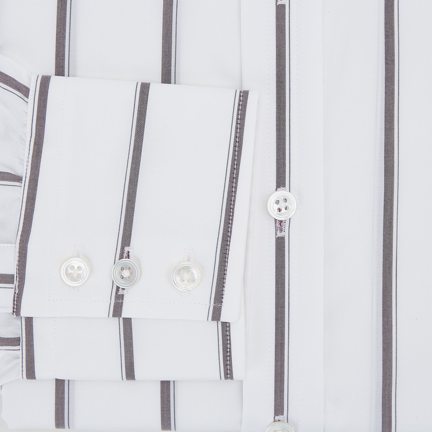 View 4 of product A Burgundy Track Stripe Mayfair Shirt by Turnbull & Asser, featuring long sleeves, vertical stripes, a classic collar, and crafted from premium Italian cotton, is displayed flat on a light background.