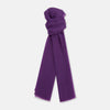 View 1 of product The Purple Cashmere Scarf by Turnbull & Asser is a luxurious, lightweight accessory, hand-dyed in purple with subtle frayed edges and a loose central knot, elegantly displayed on a plain white background.