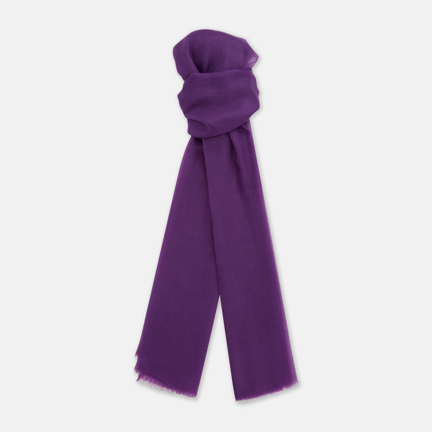 View 1 of product The Purple Cashmere Scarf by Turnbull & Asser is a luxurious, lightweight accessory, hand-dyed in purple with subtle frayed edges and a loose central knot, elegantly displayed on a plain white background.