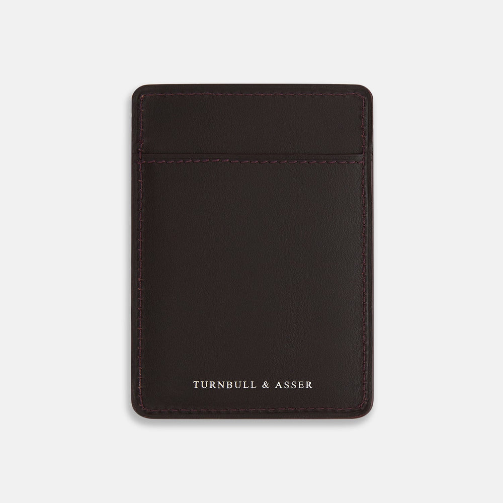 The Burgundy Two-slot Card Case by Turnbull & Asser features rich Italian leather with subtle maroon stitching and the brand embossed in white at the bottom, offering a refined minimalist accessory against a plain white background.