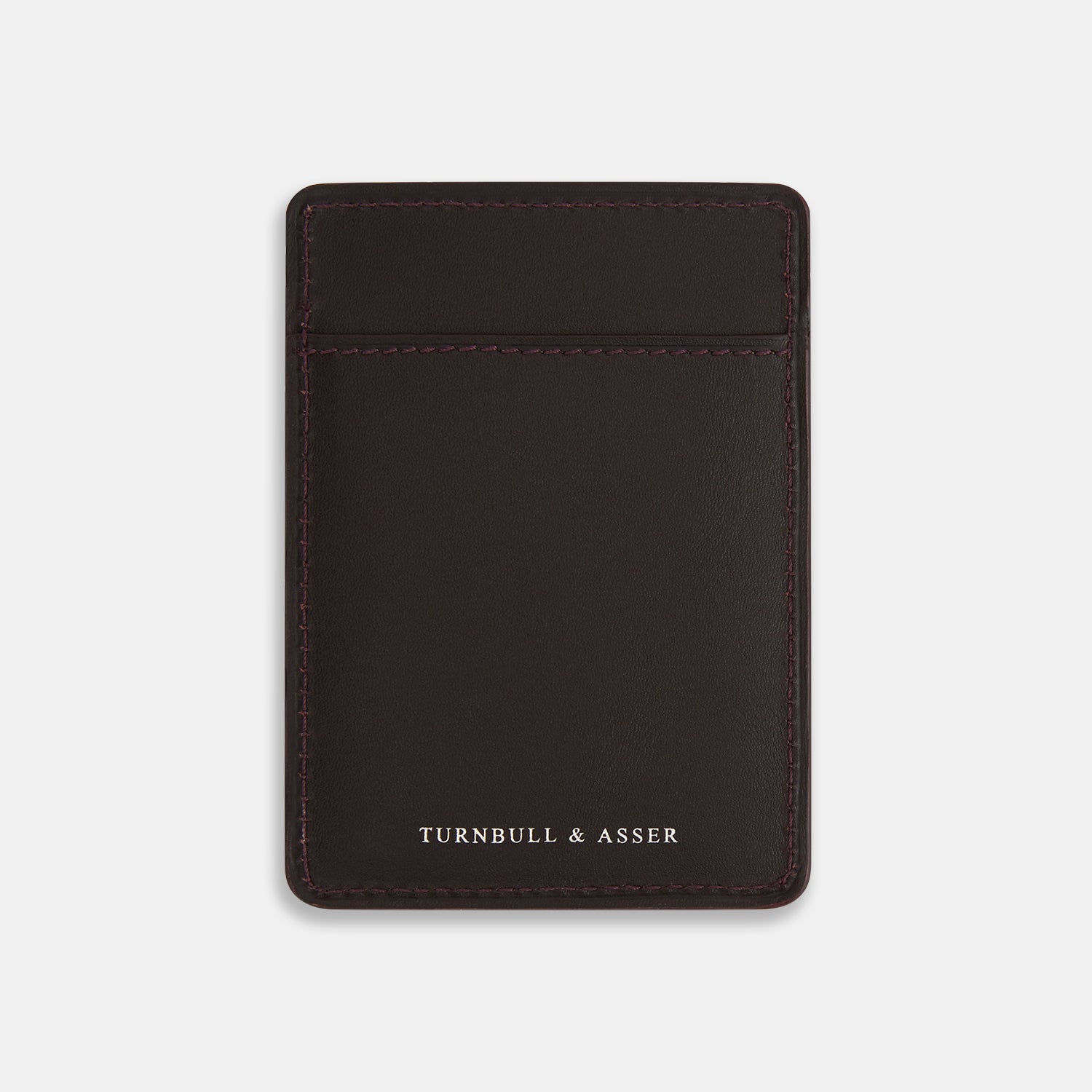 View 1 of product The Burgundy Two-slot Card Case by Turnbull & Asser features rich Italian leather with subtle maroon stitching and the brand embossed in white at the bottom, offering a refined minimalist accessory against a plain white background.