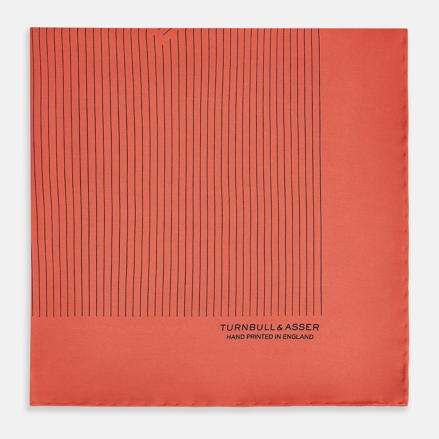 View 3 of product The Orange Stripe Silk Pocket Square by Turnbull & Asser features thin black vertical lines and "TURNBULL & ASSER HAND PRINTED IN ENGLAND" in the corner, neatly folded on a white background.