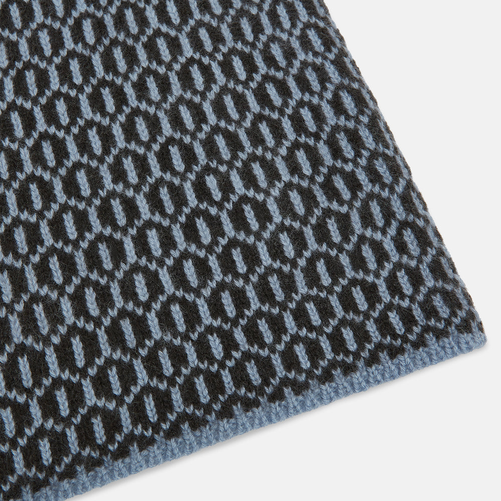 The Turnbull & Asser Dark Chocolate and Pale Blue Hexagon Cashmere Knitted Scarf is elegantly looped against a white background—an essential geometric accessory for any wardrobe.