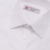 View 5 of product A neatly folded Turnbull & Asser White Oxford Shirt with T&A collar and double cuffs is displayed on a light blue background.