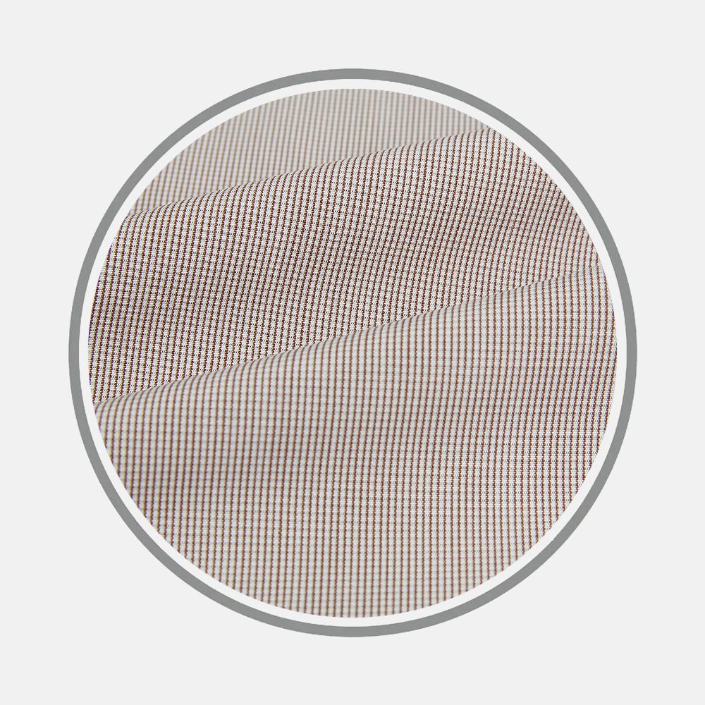 Close-up of Turnbull & Asser's Brown Micro Graph Check Fabric, featuring a beige base with a fine brown and blue grid pattern, displayed in a circular frame against a light background.