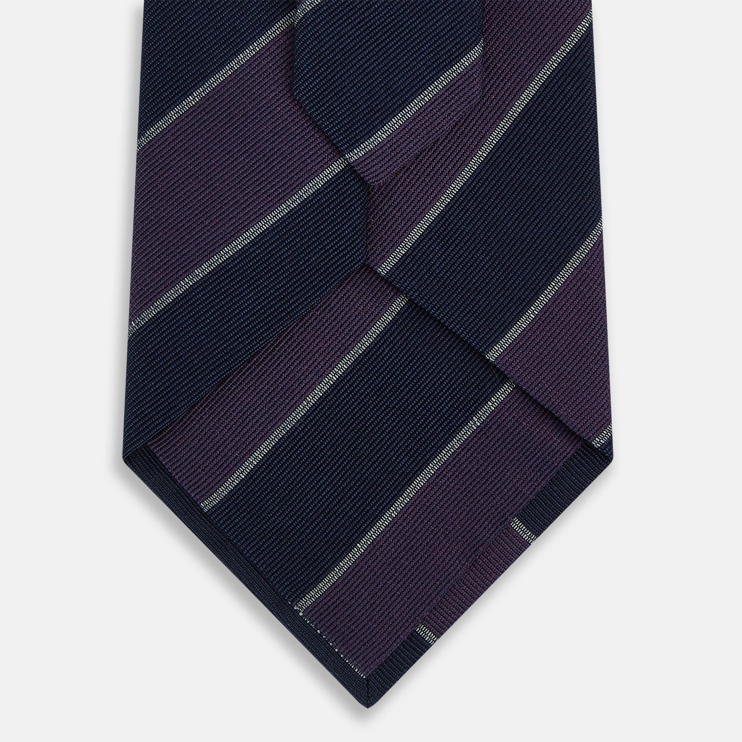 View 3 of product The Turnbull & Asser Purple And Navy Block Stripe Silk Blend Tie features dark navy and deep purple stripes with thin light gray lines, making it a refined formal accessory. Displayed on a white background.