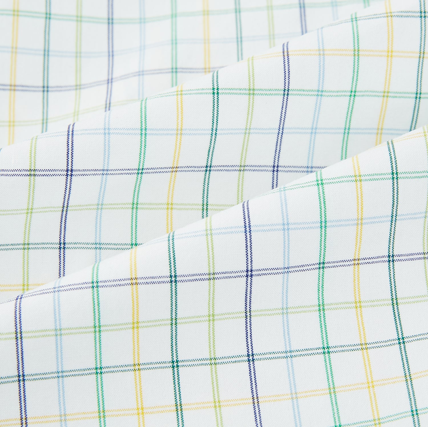 View 6 of product The Turnbull & Asser Multi Tone Double Grid Check Mayfair Shirt is a long-sleeve, button-up with a classic collar, showcasing pure cotton light blue, green, and yellow grid checks on white, neatly displayed flat against a white surface.