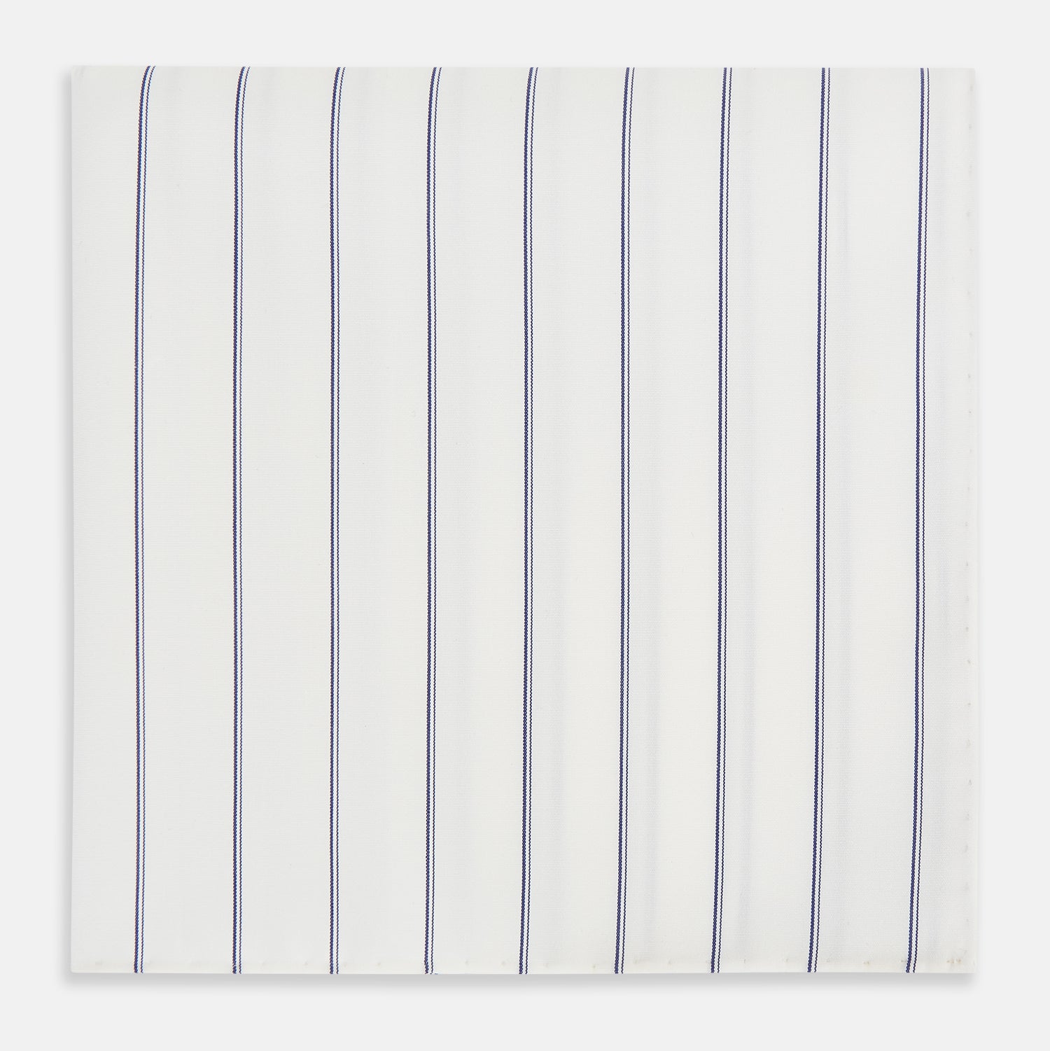 View 1 of product The Dark Navy Double-Pinstripe Hand-Rolled Handkerchief by Turnbull & Asser features white fabric with evenly spaced thin dark navy stripes and refined hand-rolled edges.