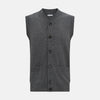 View 1 of product The Turnbull & Asser Charcoal Grey Cashmere Sleeveless Cardigan is a men's knit V-neck vest with ribbed collar, hem, and two front pockets, shown in dark grey melange against a white background.