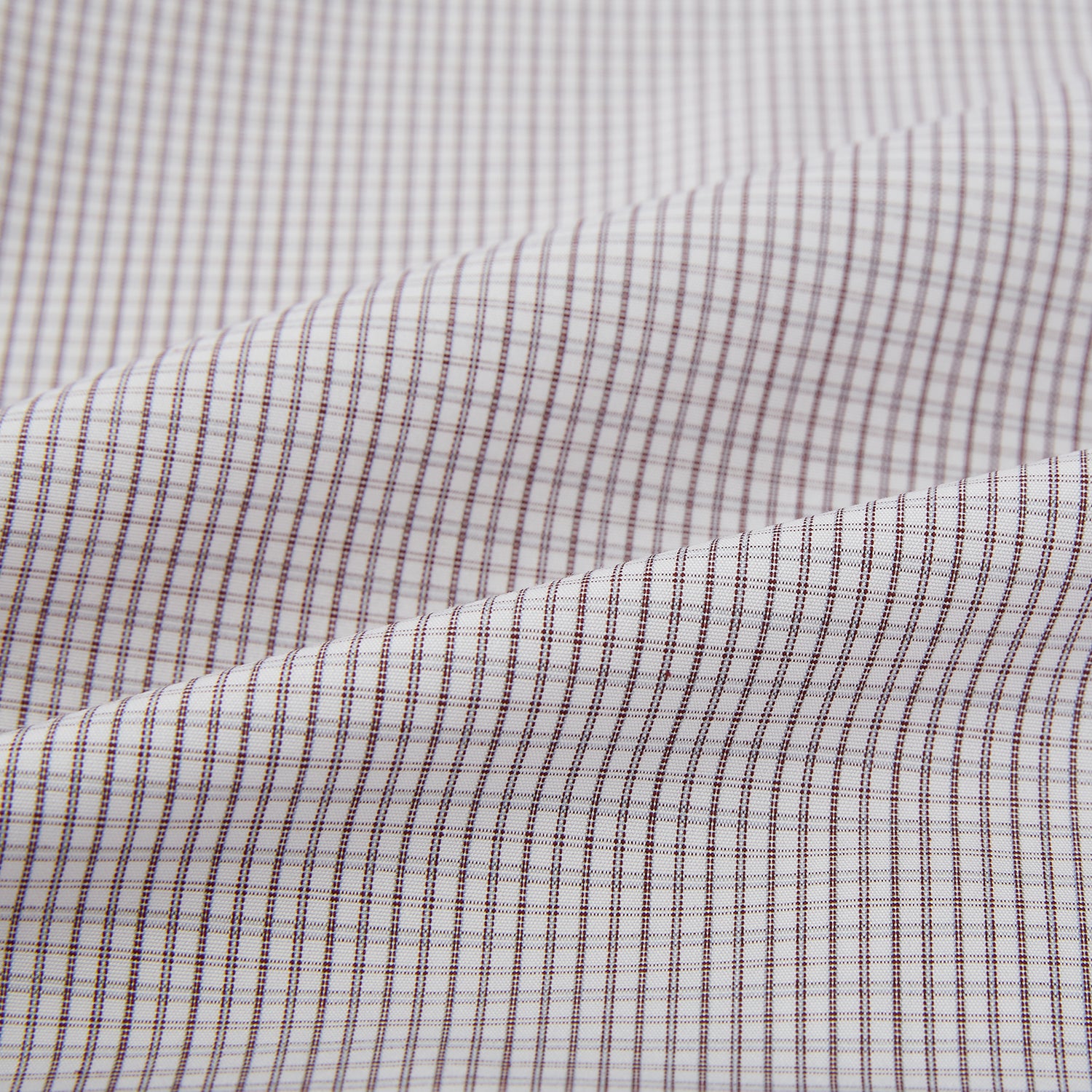View 6 of product The Turnbull & Asser Burgundy Micro Tattersall Check Mayfair Shirt, crafted from Italian cotton with long sleeves, a button-down front, collar, and buttoned cuffs, is shown on a white background.
