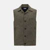 View 1 of product The Turnbull & Asser Olive Collared Linen Waistcoat is a sleeveless olive waistcoat with a collar, front buttons, one chest pocket, and two zippered side pockets, shown against a plain white background.