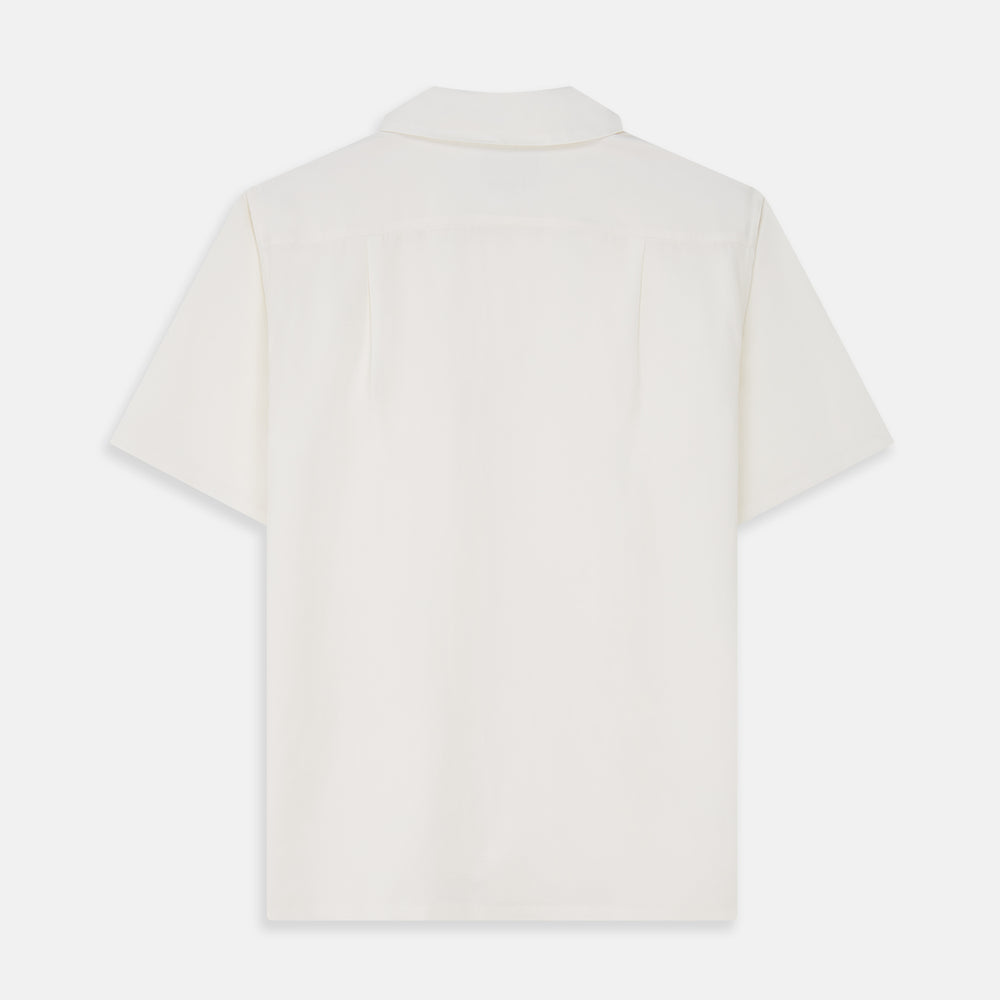 The Cream Silk Holiday Fit Phillips Shirt by Turnbull & Asser is a short-sleeved, collared silk shirt in off-white with three front pockets and a revere collar, displayed flat on a plain white background.