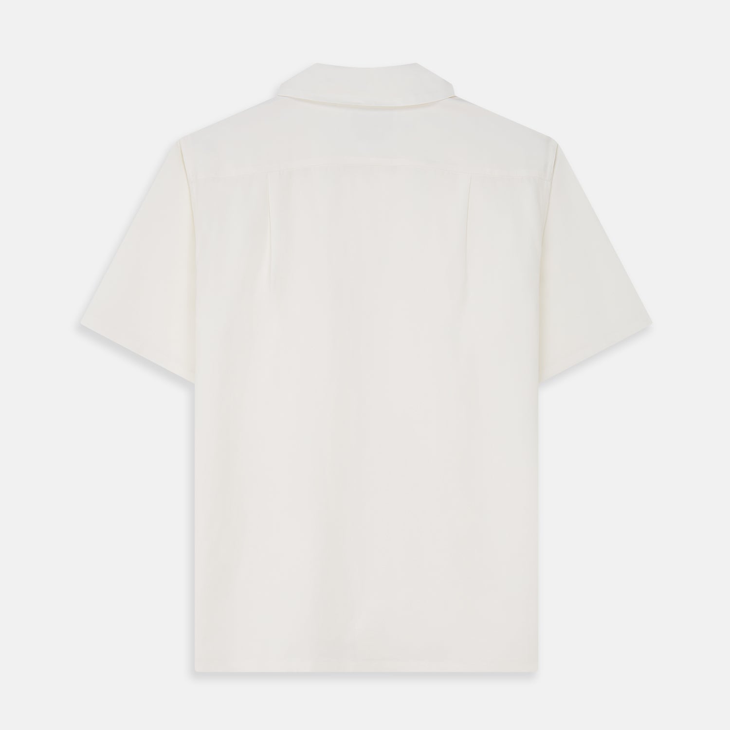 View 4 of product The Cream Silk Holiday Fit Phillips Shirt by Turnbull & Asser is a short-sleeved, collared silk shirt in off-white with three front pockets and a revere collar, displayed flat on a plain white background.