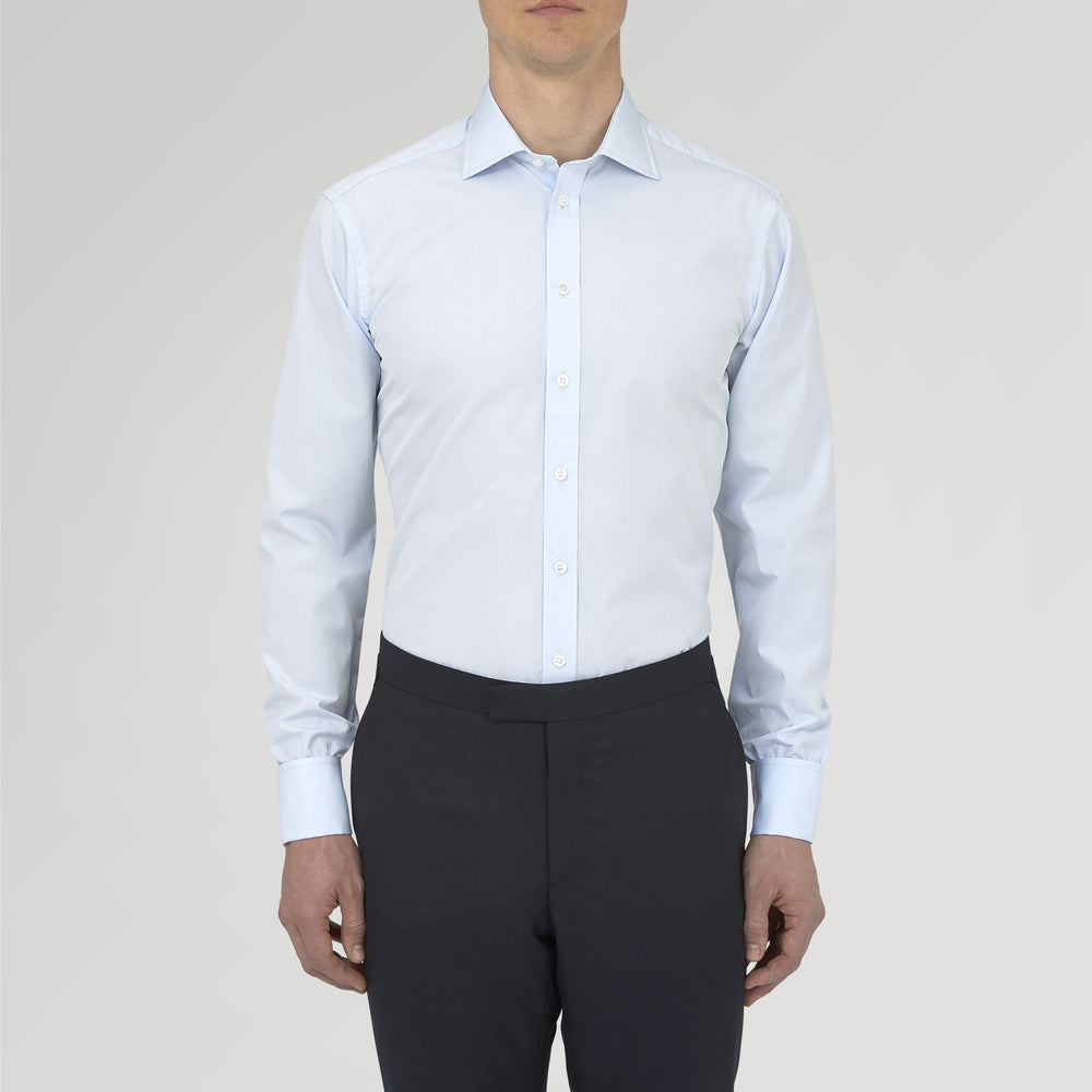 A neatly folded Turnbull & Asser Two-Fold 120 Light Blue Shirt, featuring a regent collar and double cuffs, is displayed against a plain white background.
