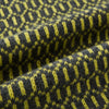 View 3 of product The Turnbull & Asser Graphite and Chartreuse Lemon Hexagon Cashmere Knitted Scarf features a geometric pattern in green and yellow tones, neatly folded to show both ends—an essential accessory with luxurious softness.