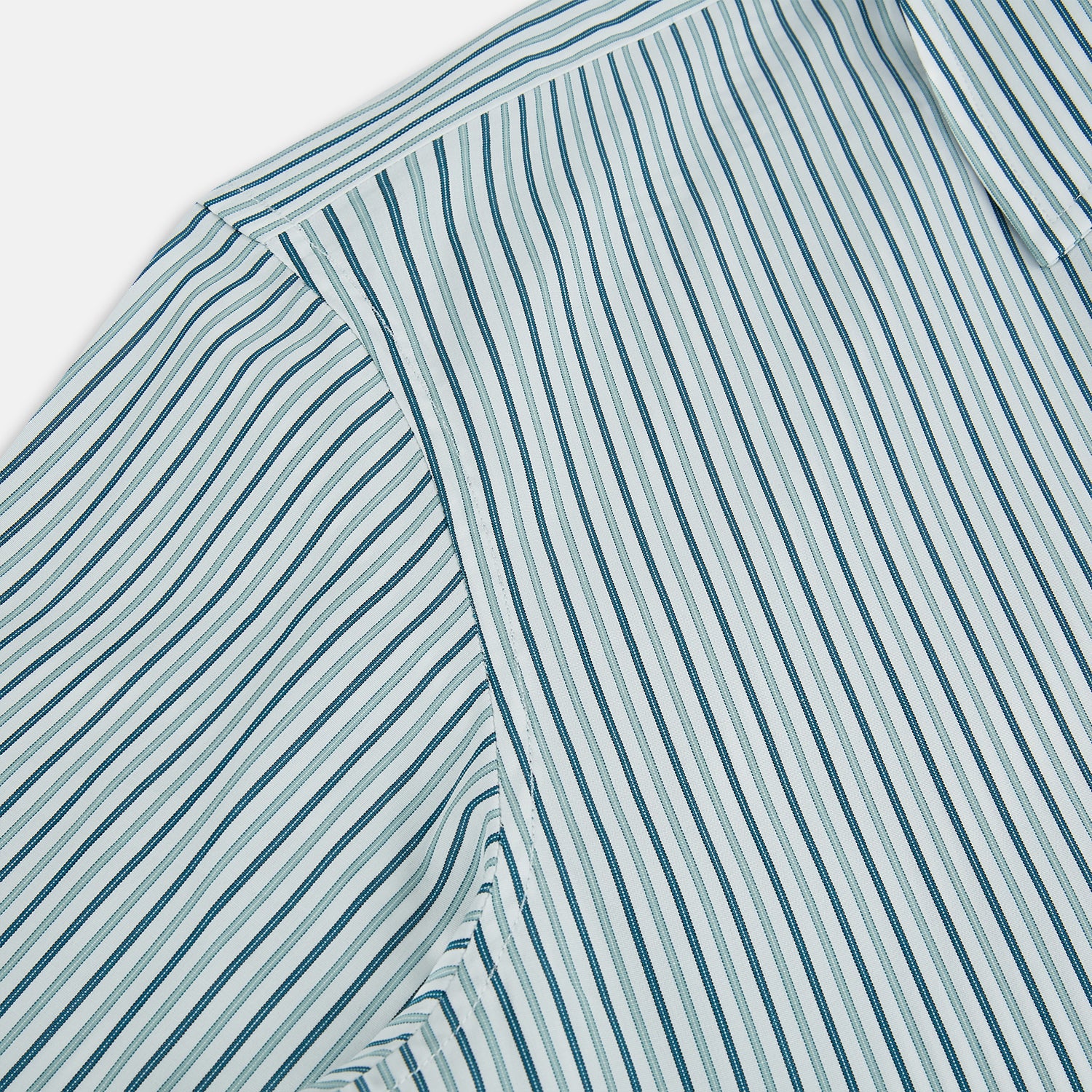 View 6 of product The GREEN DOUBLE STRIPE WESTMINSTER SHIRT by Turnbull & Asser features green and white vertical stripes, a pointed collar, buttoned cuffs, and a relaxed fit that highlights refined British craftsmanship.