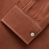 View 2 of product The Turnbull & Asser Rust Cotton Weekend Fit Blake Shirt features long sleeves, a stand collar, and white buttons—an ideal casual piece displayed flat on a white background.