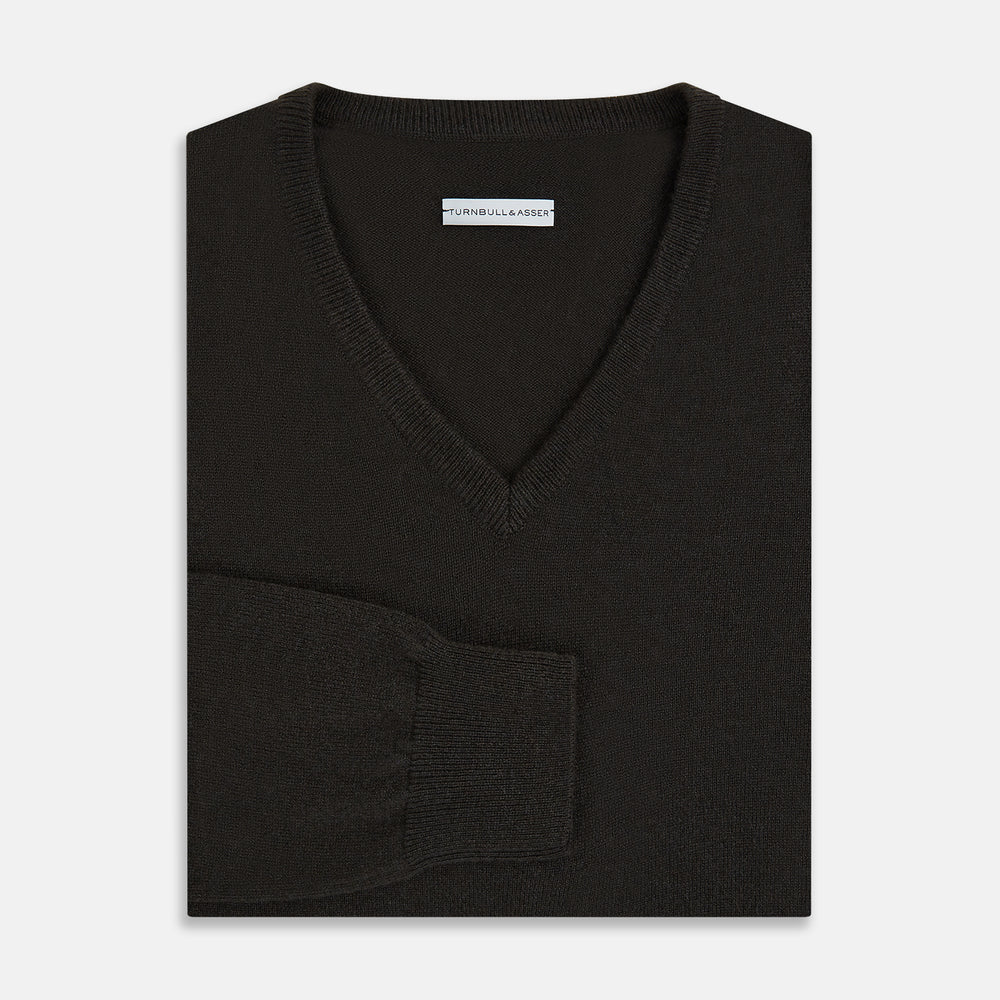 The Turnbull & Asser Dark Brown Cashmere V-Neck Jumper features long sleeves, ribbed cuffs, and a ribbed hem—timeless knitwear shown on a white background, perfect for elevating any wardrobe.