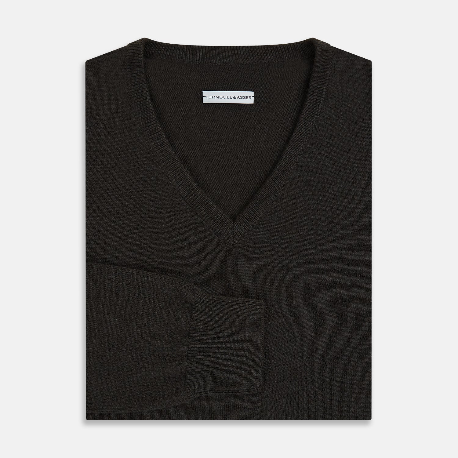 View 4 of product The Turnbull & Asser Dark Brown Cashmere V-Neck Jumper features long sleeves, ribbed cuffs, and a ribbed hem—timeless knitwear shown on a white background, perfect for elevating any wardrobe.