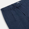 View 2 of product Turnbull & Asser Denim Blue Linen Herringbone Miles Trousers with a straight-leg fit, elasticated waist, and drawstring tie, shown against a plain white background.