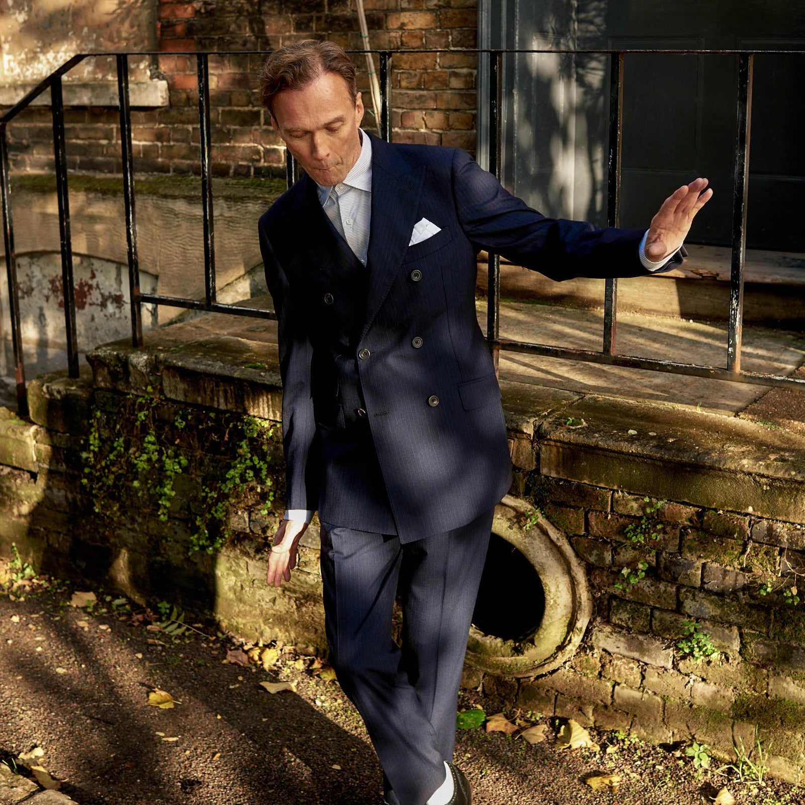 View 2 of product The Turnbull & Asser Navy Wool Pinstripe Double-Breasted Jacket features peak lapels, four front buttons, and three front pockets, and is displayed on a plain white background.