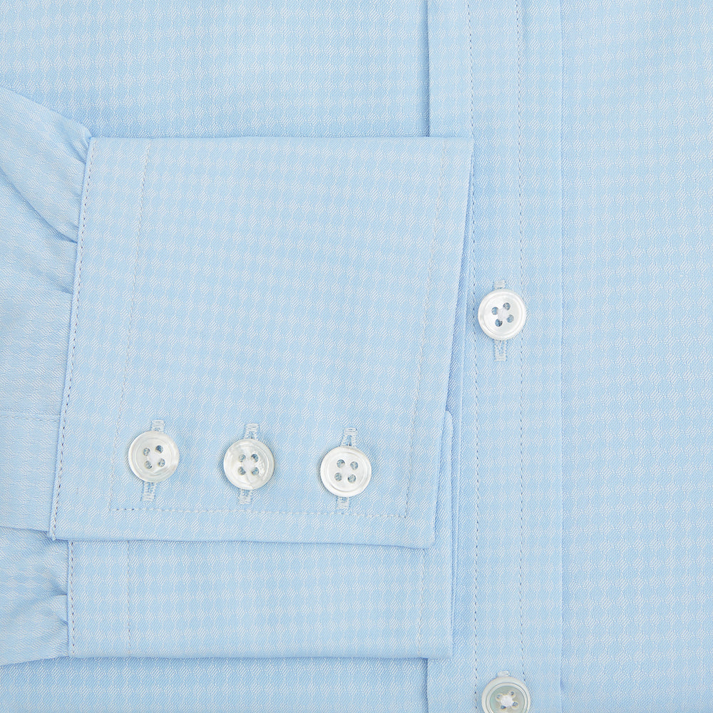 The Pale Blue Rhombus Mayfair Shirt by Turnbull & Asser features long sleeves, a classic collar, white buttons, and buttoned cuffs, shown laid flat on a white background.