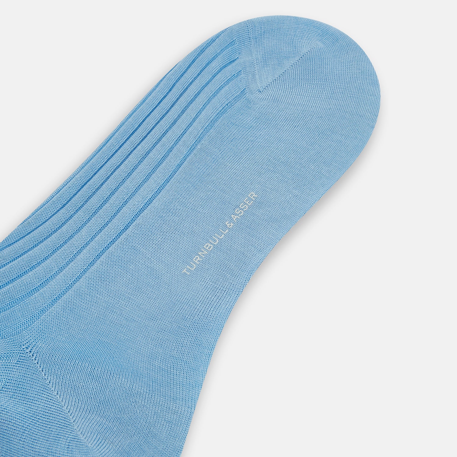 View 3 of product A single Turnbull & Asser Pale Blue Mid-Length Sock, made from Egyptian cotton with a ribbed texture, is displayed upright against a plain white background.