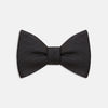 View 1 of product The Turnbull & Asser Black Herringbone Silk Bow Tie, ideal for formal occasions, features a subtle herringbone pattern and is shown against a plain white background.