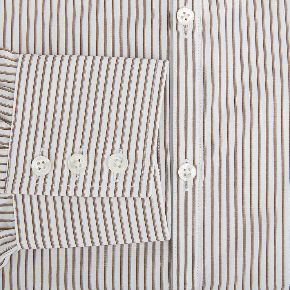 The Turnbull & Asser Coffee Multi Stripe Westminster Shirt features long sleeves, a button-up front, subtle beige and white stripes, a pointed Turnbull collar, and buttoned cuffs—expertly crafted in Britain and shown flat on a white background.