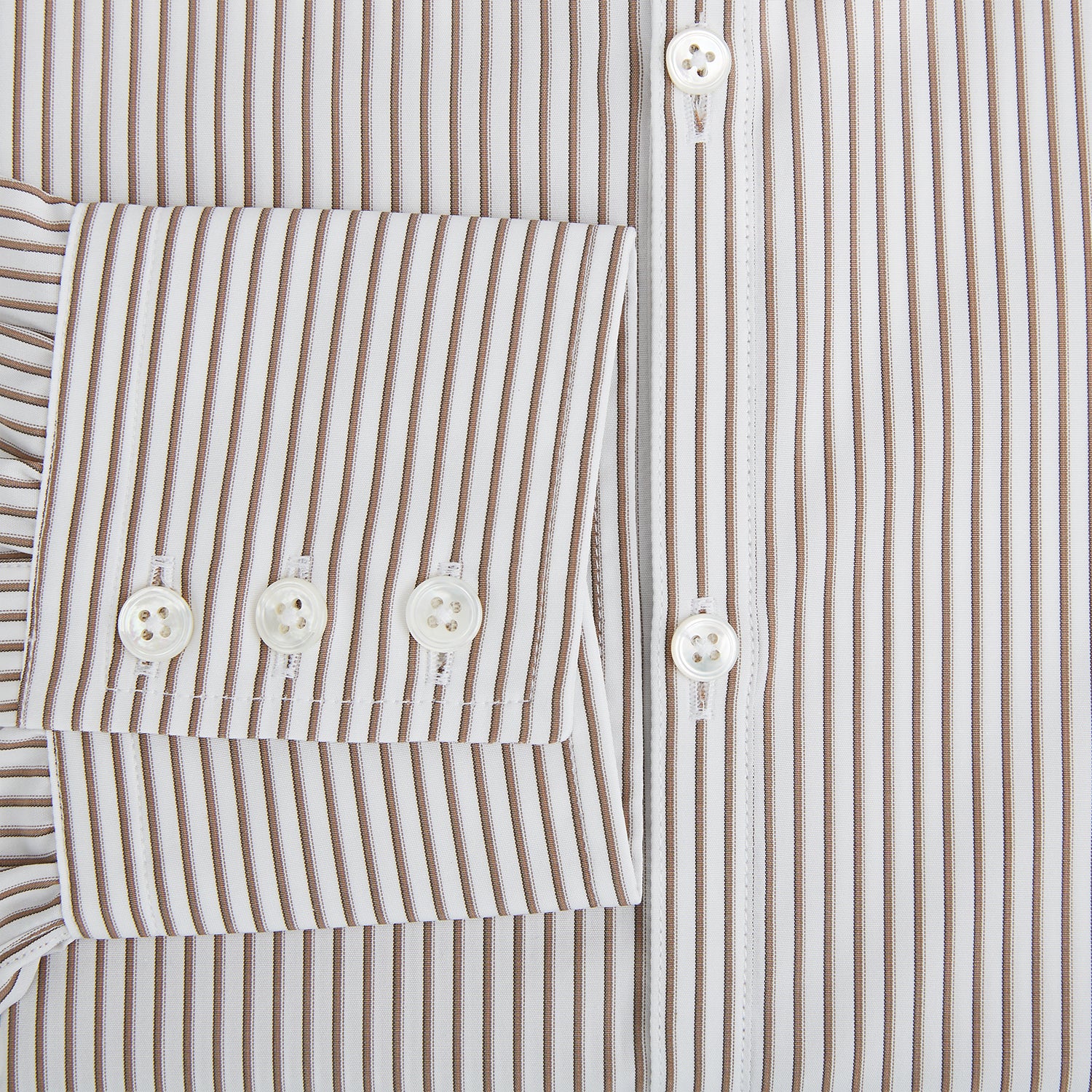 View 4 of product The Turnbull & Asser Coffee Multi Stripe Westminster Shirt features long sleeves, a button-up front, subtle beige and white stripes, a pointed Turnbull collar, and buttoned cuffs—expertly crafted in Britain and shown flat on a white background.