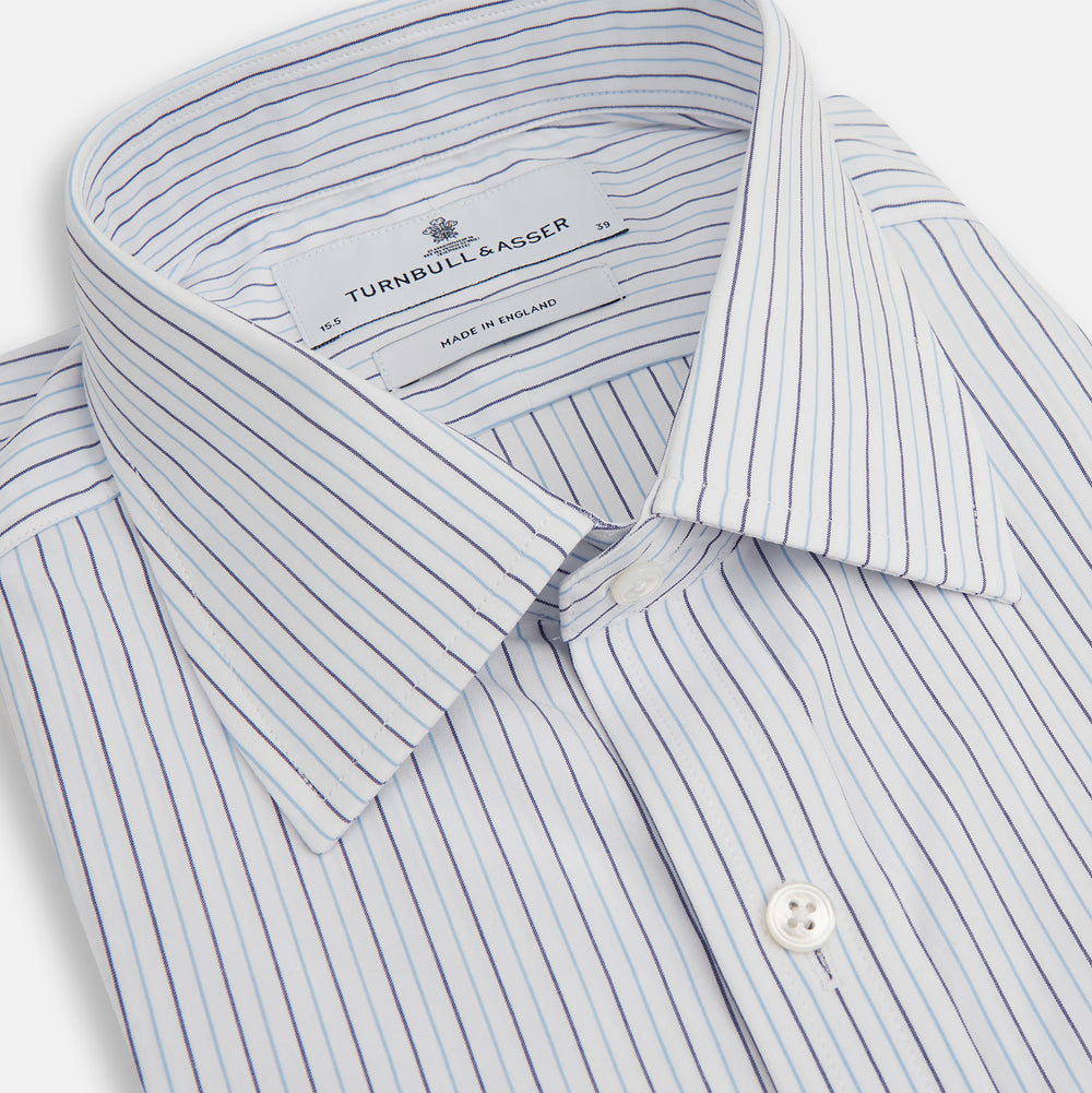 The Blue Double Pinstripe Mayfair Shirt by Turnbull & Asser is made from organic cotton with thin blue and white stripes, a pointed collar, and buttoned cuffs—perfect for elevating your workweek rotation.