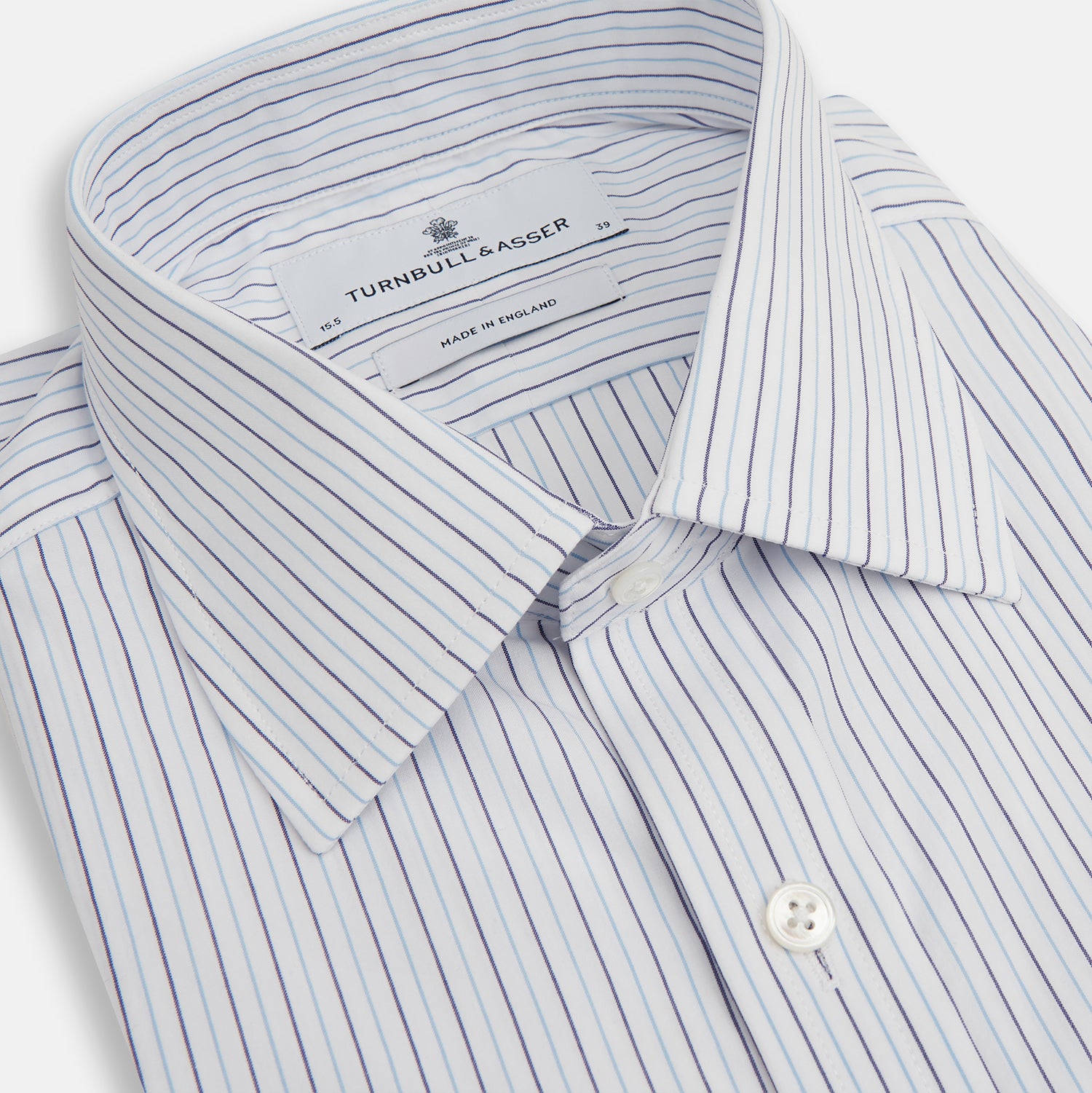 View 2 of product The Blue Double Pinstripe Mayfair Shirt by Turnbull & Asser is made from organic cotton with thin blue and white stripes, a pointed collar, and buttoned cuffs—perfect for elevating your workweek rotation.