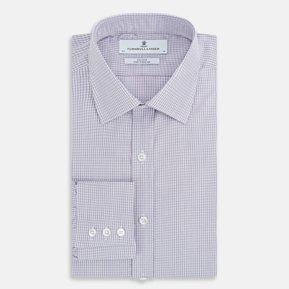The Turnbull & Asser Purple Micro Check Mayfair Shirt features long sleeves, button-up front, pointed collar, and buttoned cuffs in a subtle lilac and white check, exemplifying British craftsmanship and displayed on a white background.