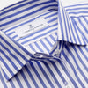 View 2 of product The Turnbull & Asser Pale Blue Candy Stripe Cotton Marlene Shirt is an oversized women's collared shirt with long sleeves, buttoned cuffs, and vertical blue and white stripes, shown laid flat on a white background.