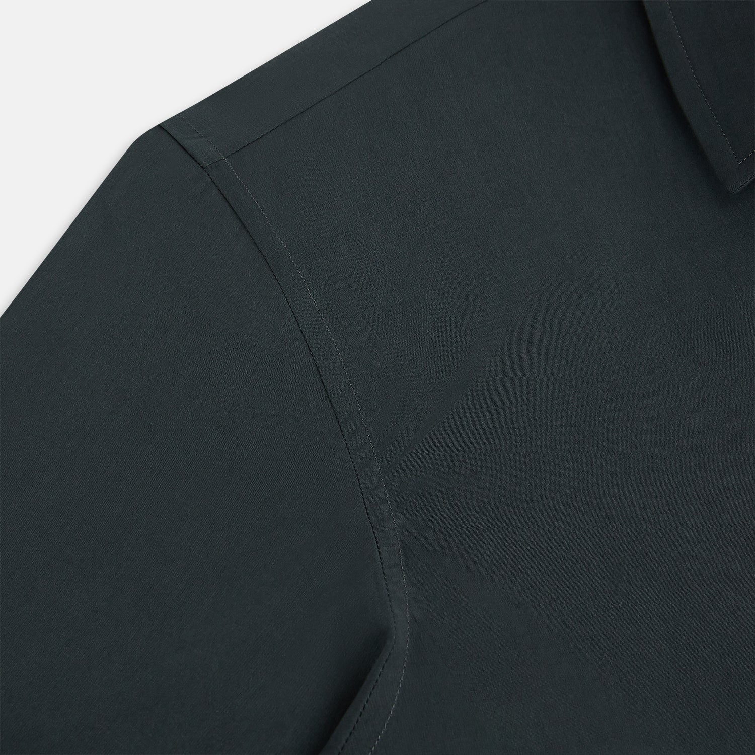 View 6 of product The Charcoal Windsor Shirt by Turnbull & Asser is a black, long-sleeve button-up with a pointed Windsor collar, buttoned cuffs, and a straight hem, shown flat on a white background.