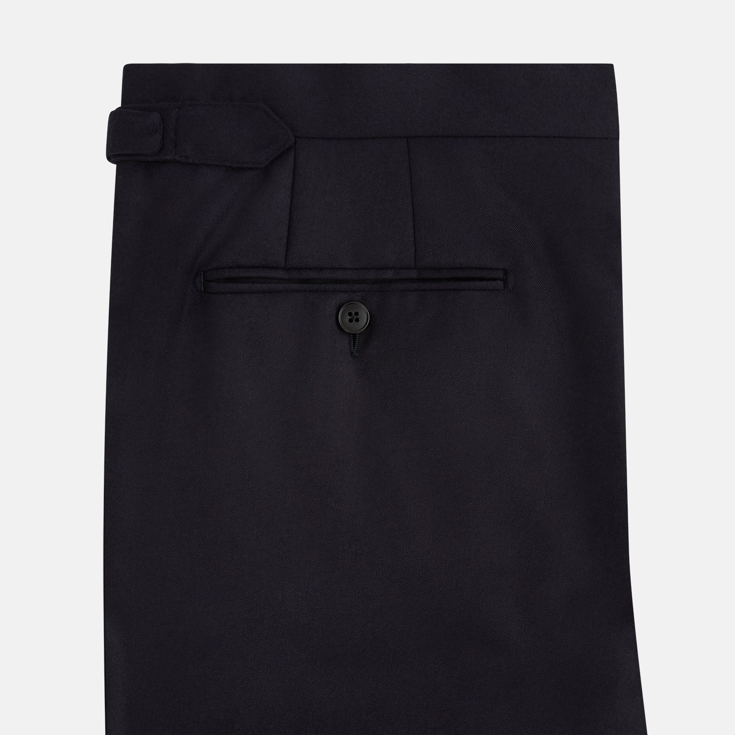 View 9 of product The Turnbull & Asser Short Navy Single Breasted Suit is shown flat on a white background, with a notch lapel jacket featuring two front pockets and matching trousers neatly folded underneath.