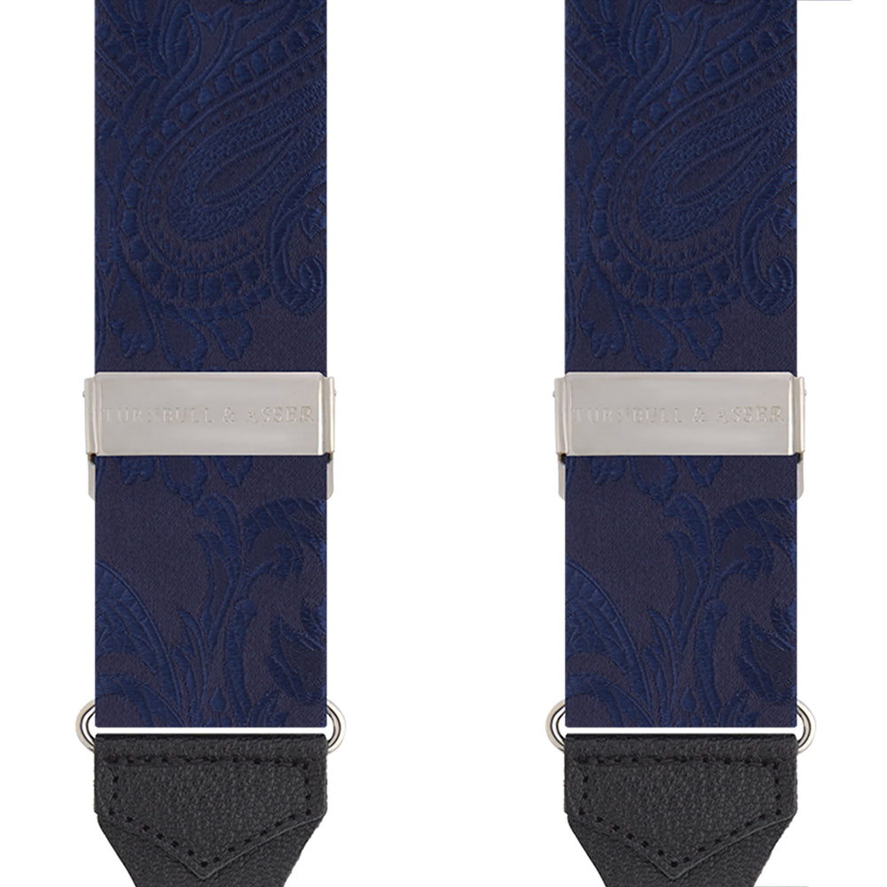 Turnbull & Asser’s Navy Paisley Adjustable Silk Braces feature subtle paisley patterns, silver hardware, and black leather ends with looped attachments, shown laid flat on a white background.