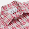 View 3 of product The Turnbull & Asser Red Check Cotton Weekend Fit Finch Shirt is a men's long-sleeved, button-up shirt with a Derby collar and red-and-white plaid pattern, displayed flat on a white background.