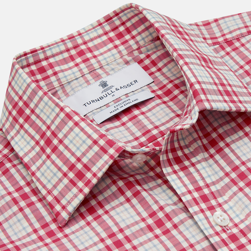 The Turnbull & Asser Red Check Cotton Weekend Fit Finch Shirt is a men's long-sleeved, button-up shirt with a Derby collar and red-and-white plaid pattern, displayed flat on a white background.